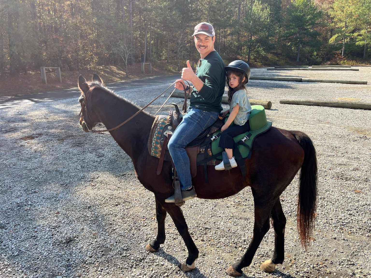 An instructor and young rider on horseback